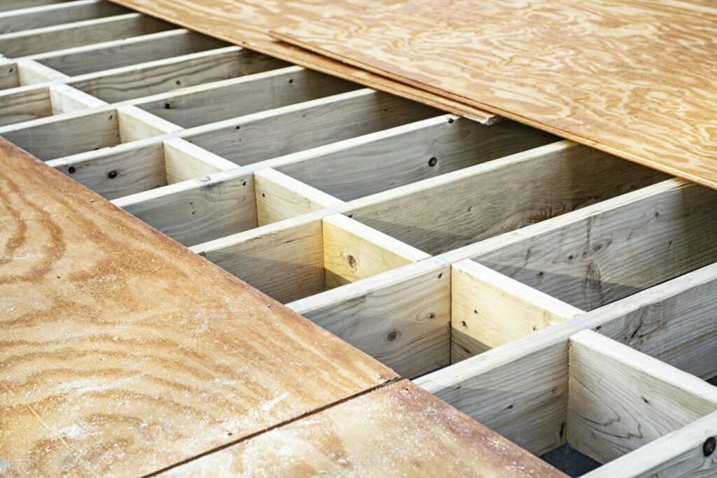 Wood floor joists with blocking and subfloor sheathing, part of coordinating engineered lumber and floor systems